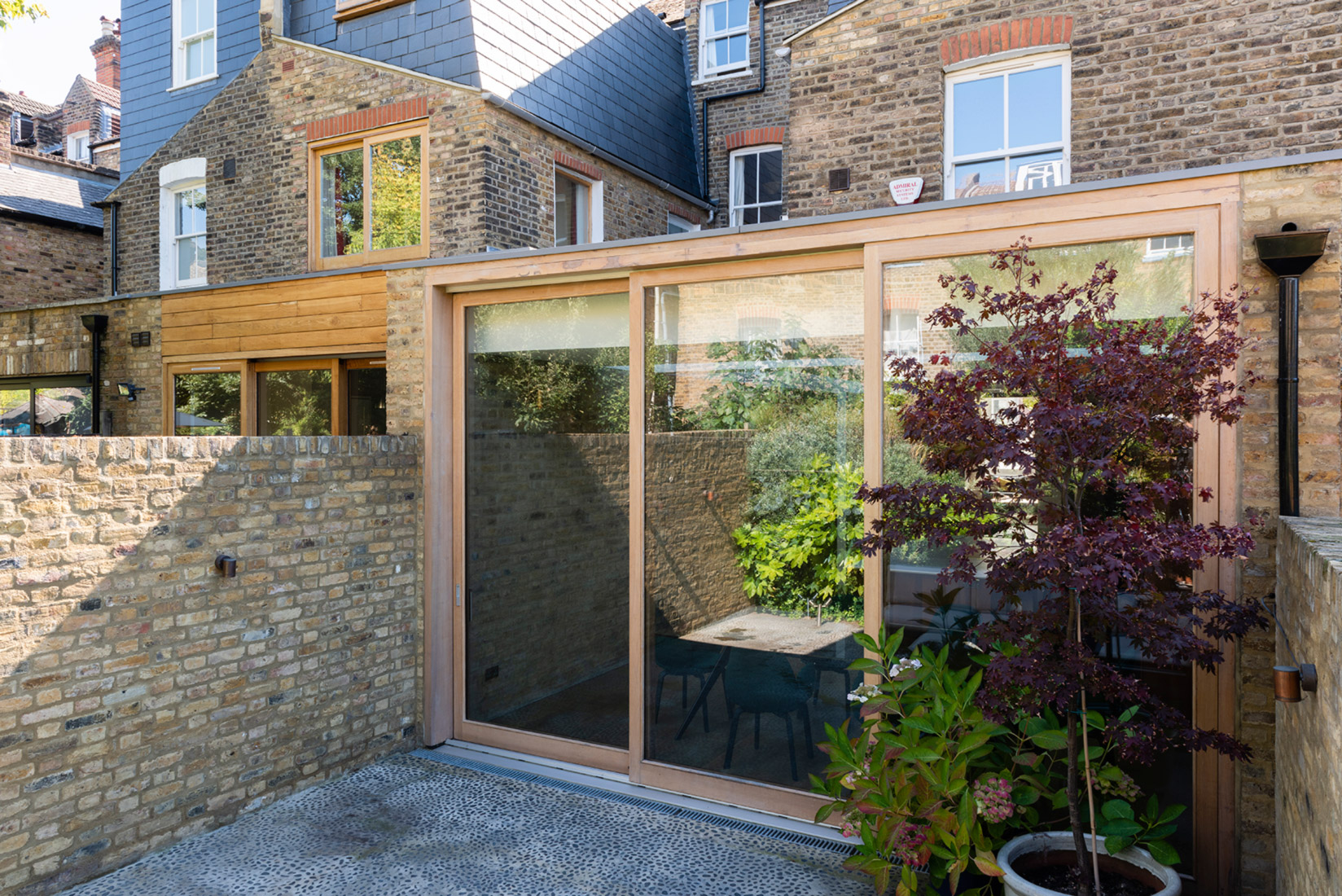 Garden view to house exterior brick wall