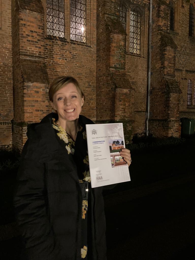 Picture of architect holding certificate of commendation